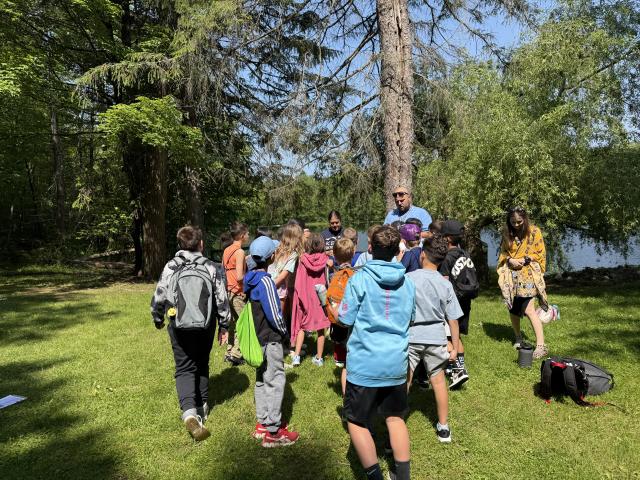 Group of students listening to a Kean professional while exploring nature