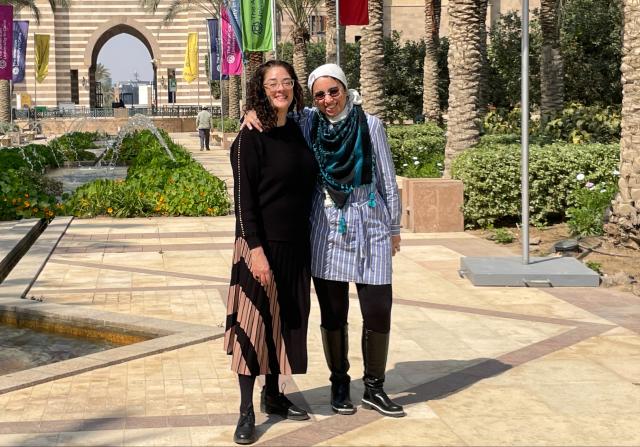 Kean professor in a courtyard with a colleague