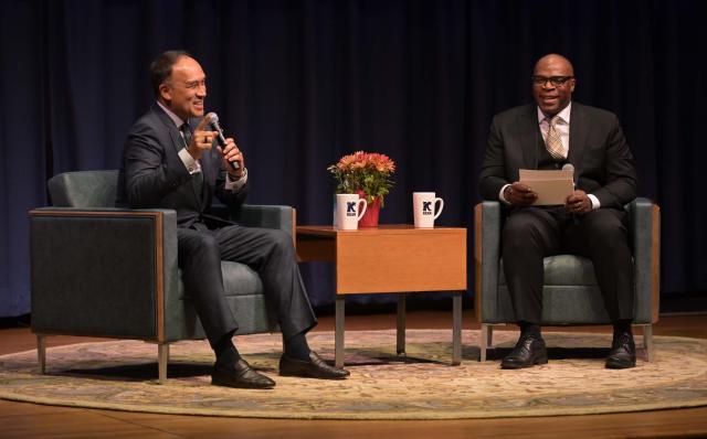 Mark Tatum speaks on stage at Kean alongside Kelly Williams, vice president of athletics and recreation.