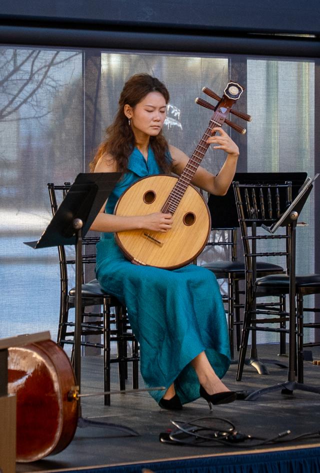 A musician plays a traditional Chinese instrument 