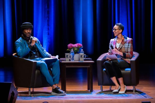 Nate Burleson speaking on stage with First Lady Darlene Repollet