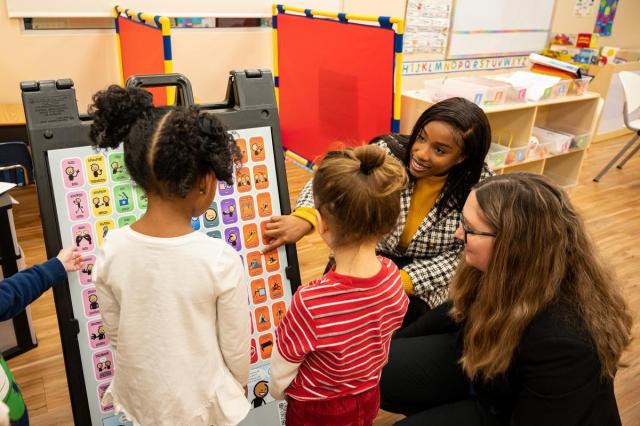 Young students learning from a teacher 
