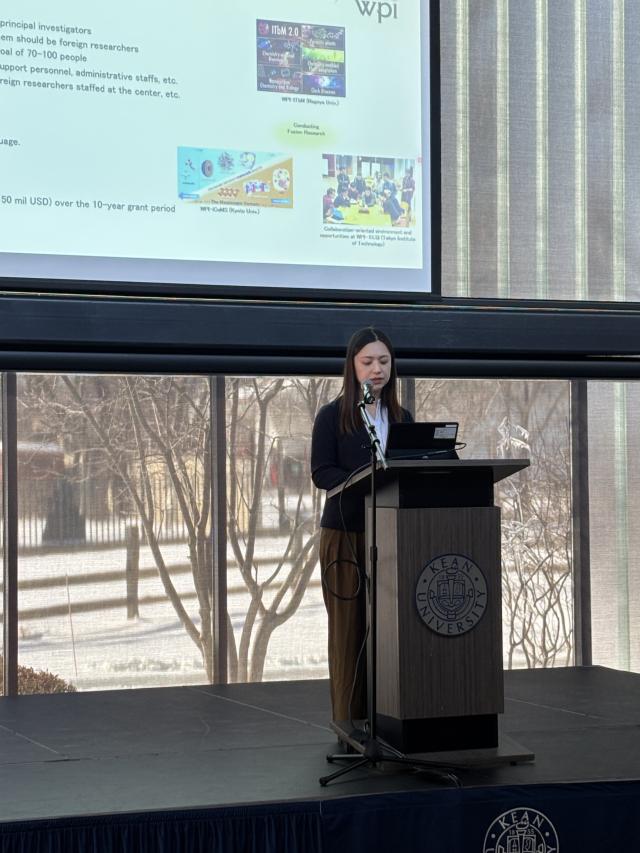 A conference speaker presents at Dialogue Between the West and East