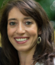 Picture of women with brown hair smiling at camera.