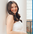 Picture of women with brown hair smiling at camera.