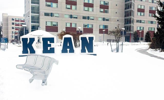 The Kean University campus and Kean sign covered in snow. 