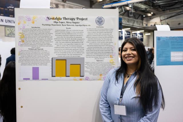 Student in front of a poster presenting