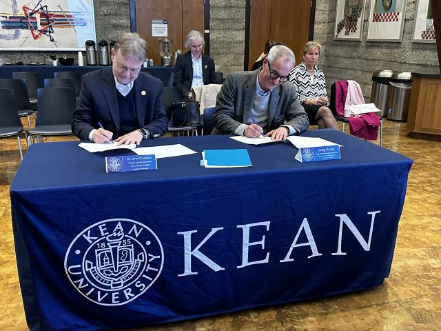NJCU Senate President Dr. John Donnellan and Kean University Senate Chair, Craig Konyk signing Resolution 1