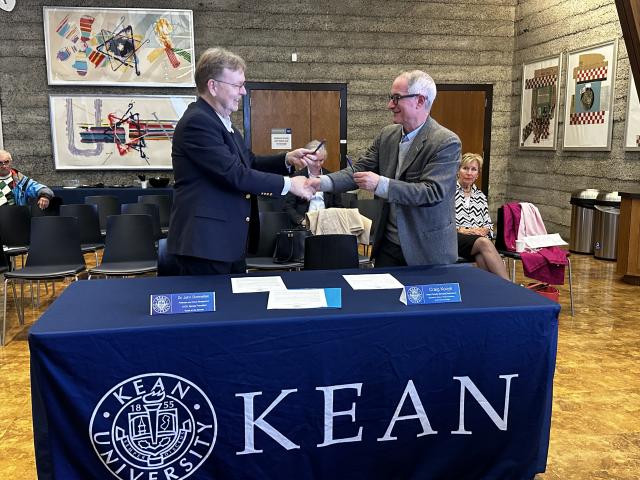 NJCU Senate President Dr. John Donnellan and Kean University Senate Chair, Craig Konyk finalizing signing of Resolution 1