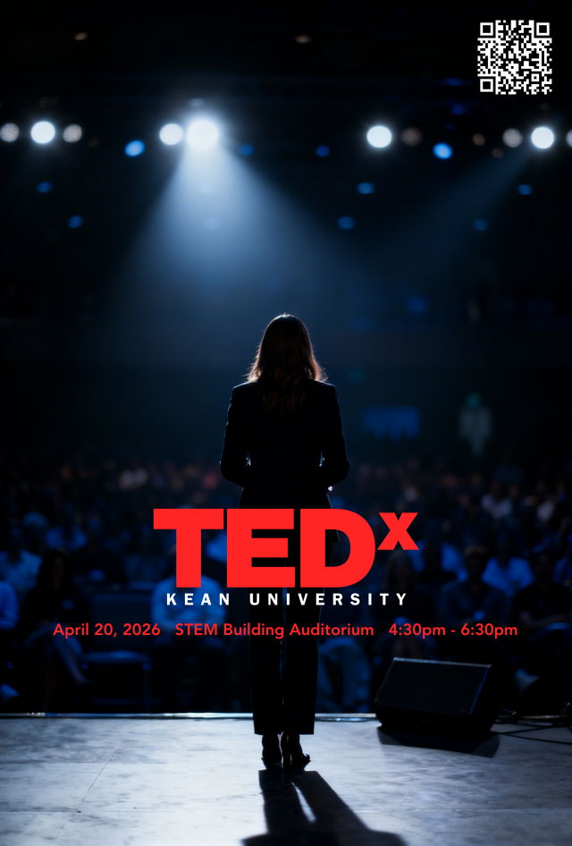 A woman stands on a stage in front of a crowd