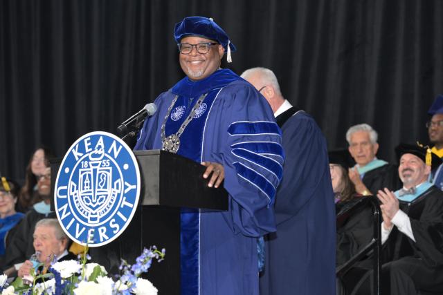 Man speaking at a podium on a stage