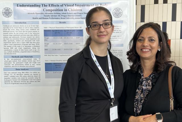 Two women in front of a poster