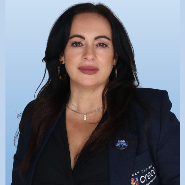 Hispanic female with long black hair wearing a dark blue suit jacket