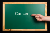 Blackboard with hand pointing to the  word "Cancer" (topic for this virtual booth)