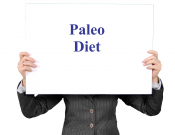 person holding a sign that says "Paleo Diet" (topic of presentation)