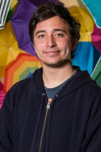 Theatre Education Major James Fogerty ‘20 in front of a backdrop of colorful umbrellas